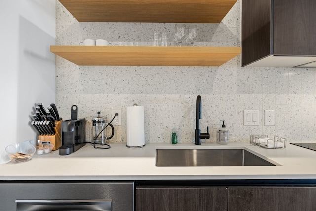 kitchen featuring sink, dark brown cabinetry, backsplash, and wine cooler