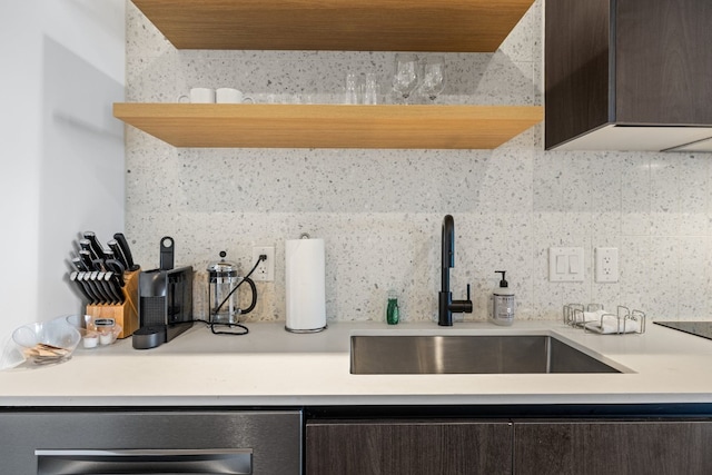 48 E Ave Unit 1607, Austin, TX 78701 - kitchen view of dark brown cabinets, light countertops, and tasteful backsplash