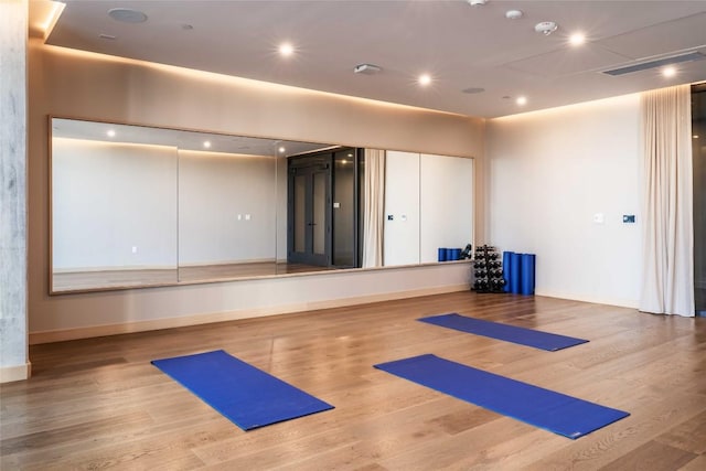 exercise area featuring hardwood / wood-style floors and basketball court