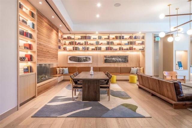 dining room featuring built in features and light hardwood / wood-style floors