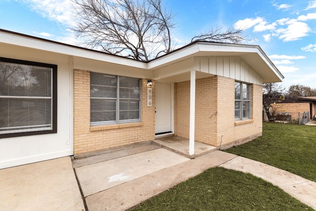 doorway to property with a yard