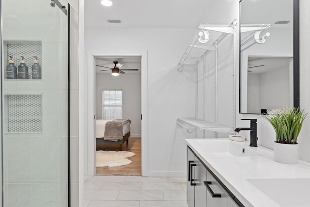 bathroom with vanity, a shower with door, and ceiling fan