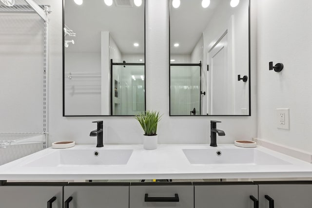 bathroom featuring vanity and a shower with shower door