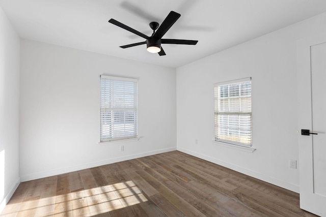 empty room featuring dark wood-type flooring and ceiling fan