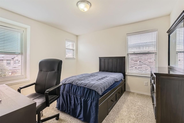 carpeted bedroom featuring multiple windows