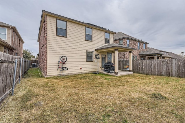 back of property with a lawn and a patio area