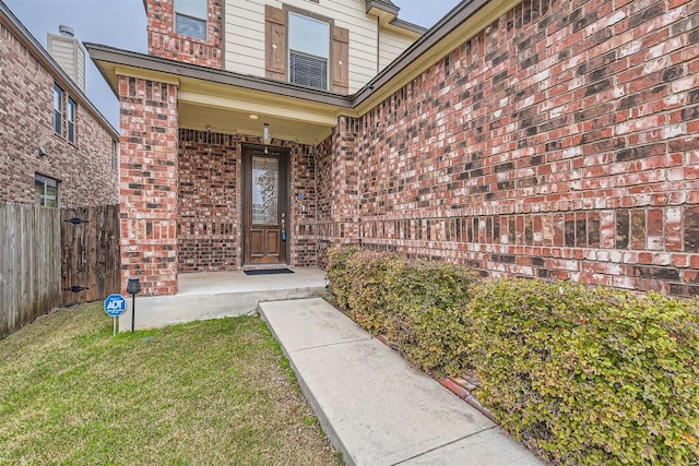 doorway to property with a yard