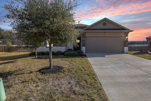 view of front of house with a yard and a garage