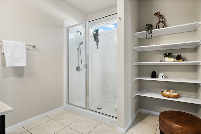 bathroom featuring tile patterned floors and a shower with shower door