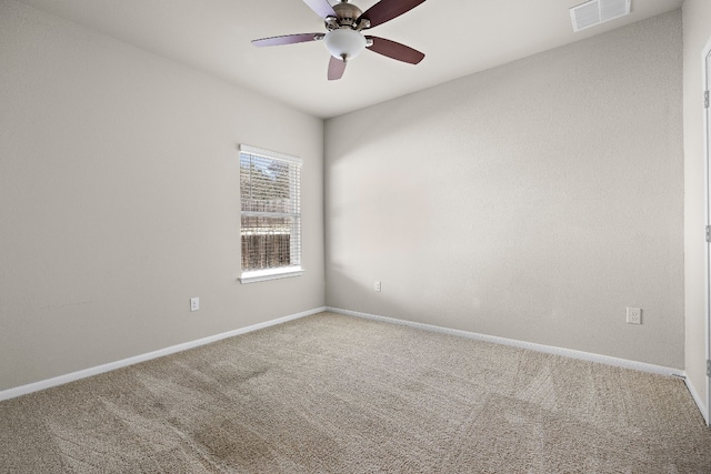 carpeted spare room featuring ceiling fan