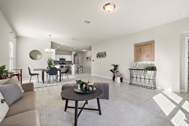 living room featuring light tile patterned floors and a chandelier