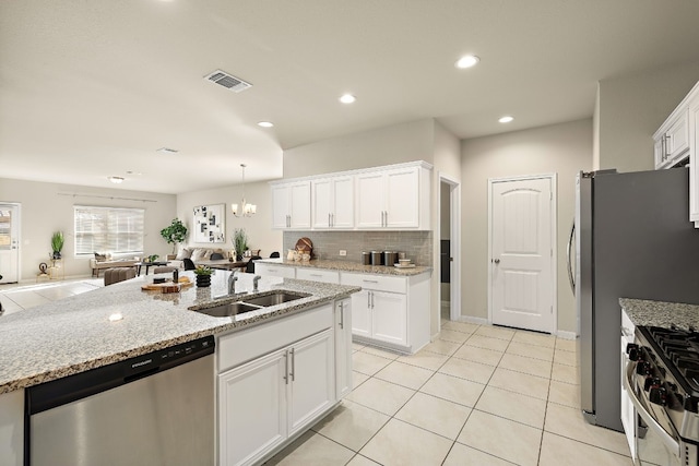 kitchen featuring white cabinetry, sink, stainless steel appliances, light stone counters, and light tile patterned floors