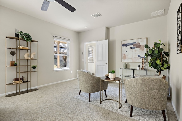 sitting room featuring carpet and ceiling fan