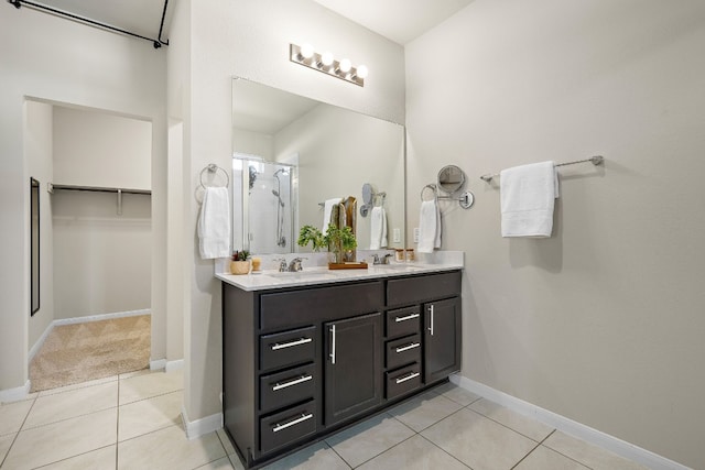 bathroom featuring tile patterned flooring, vanity, and an enclosed shower