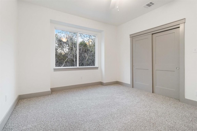 unfurnished bedroom with ceiling fan and carpet