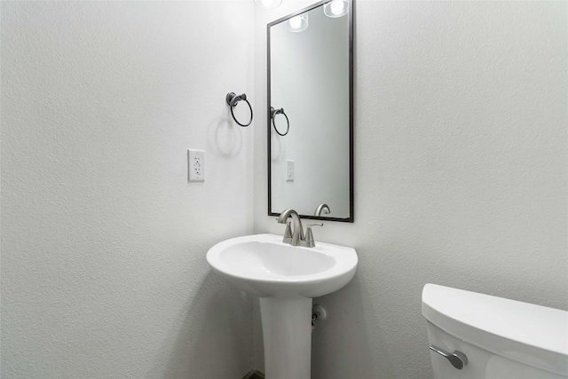 bathroom with toilet and sink