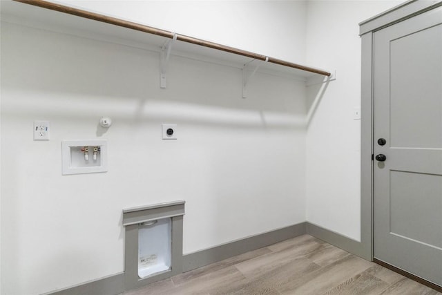 laundry area with hookup for an electric dryer, washer hookup, light wood-type flooring, and gas dryer hookup