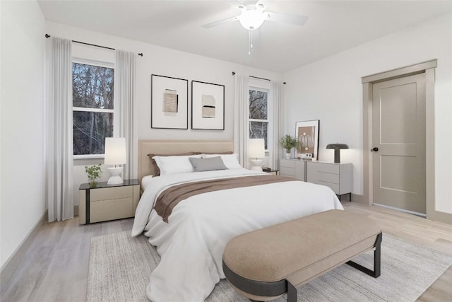 bedroom with ceiling fan and light hardwood / wood-style floors