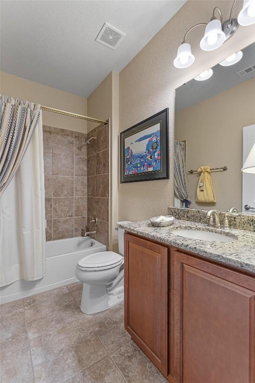 full bath featuring visible vents, shower / bathtub combination with curtain, toilet, and vanity