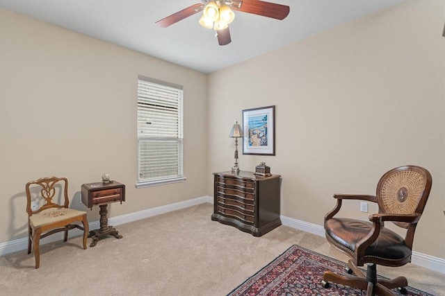 living area with light carpet, ceiling fan, and baseboards