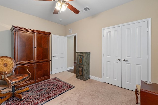 sitting room featuring light carpet, a ceiling fan, visible vents, and baseboards