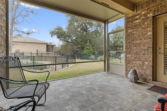 unfurnished sunroom with beam ceiling