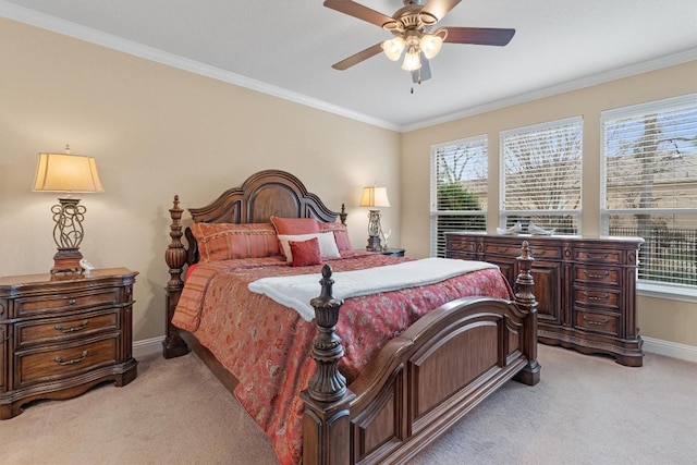 carpeted bedroom with multiple windows, ceiling fan, and crown molding