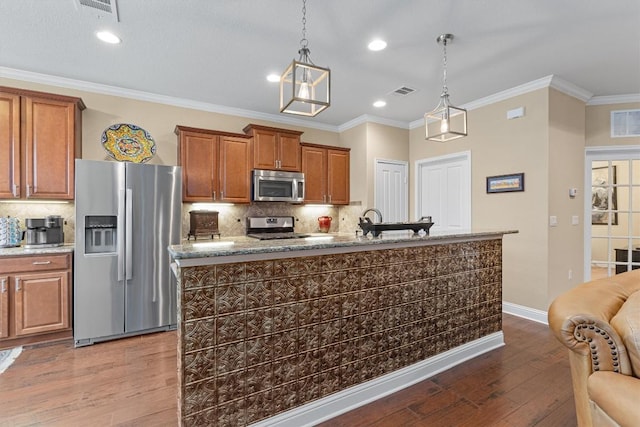 kitchen with brown cabinets, dark wood-style flooring, stainless steel appliances, and crown molding