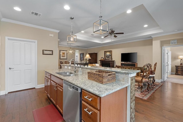 kitchen with a raised ceiling, stainless steel dishwasher, a sink, and visible vents