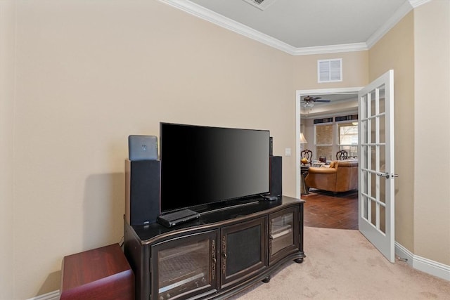 home office featuring crown molding, french doors, ceiling fan, and light colored carpet