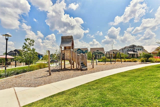 view of playground with a lawn