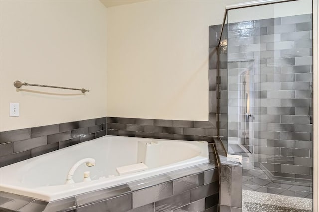 bathroom featuring tiled bath