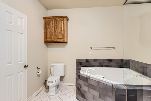 bathroom featuring tiled bath, tile patterned flooring, and toilet