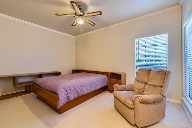 carpeted bedroom with ceiling fan and ornamental molding