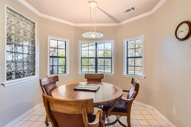 tiled dining space featuring crown molding