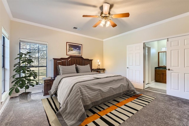 carpeted bedroom with ensuite bath, ceiling fan, and crown molding