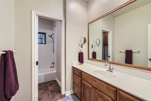 bathroom featuring vanity and tiled shower / bath