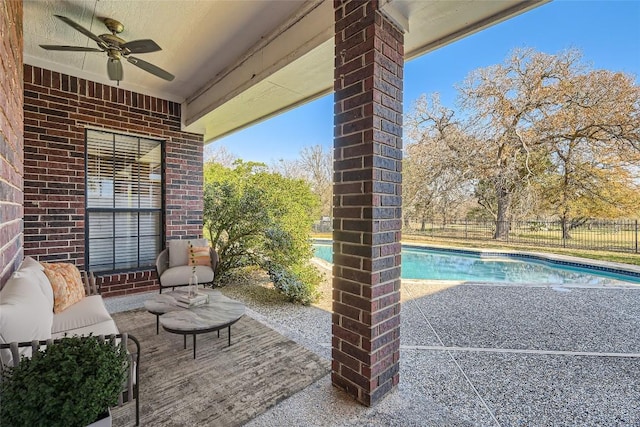 view of patio / terrace featuring ceiling fan and a fenced in pool