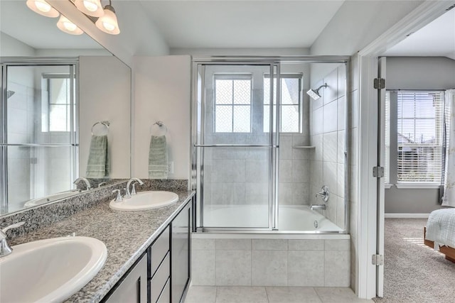 bathroom featuring a healthy amount of sunlight, tile patterned flooring, vanity, and enclosed tub / shower combo