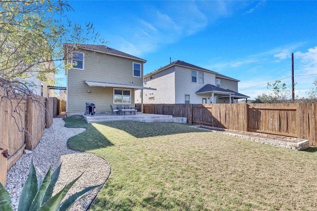 rear view of property with a lawn and a patio