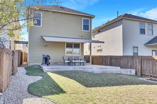 rear view of house featuring a yard and a patio