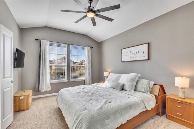 bedroom featuring ceiling fan, light colored carpet, and vaulted ceiling