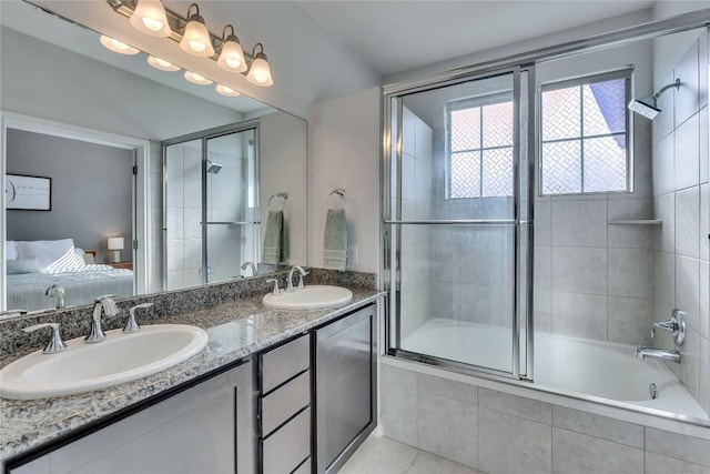 bathroom featuring shower / bath combination with glass door, tile patterned floors, and vanity