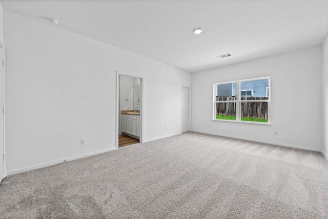 empty room featuring light colored carpet