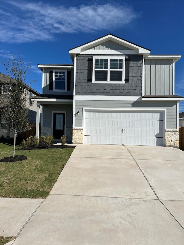 view of front of home with a front yard and a garage