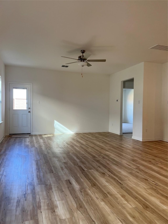 unfurnished living room with ceiling fan and light hardwood / wood-style floors