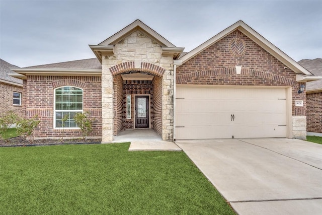 view of front of property featuring a garage and a front lawn