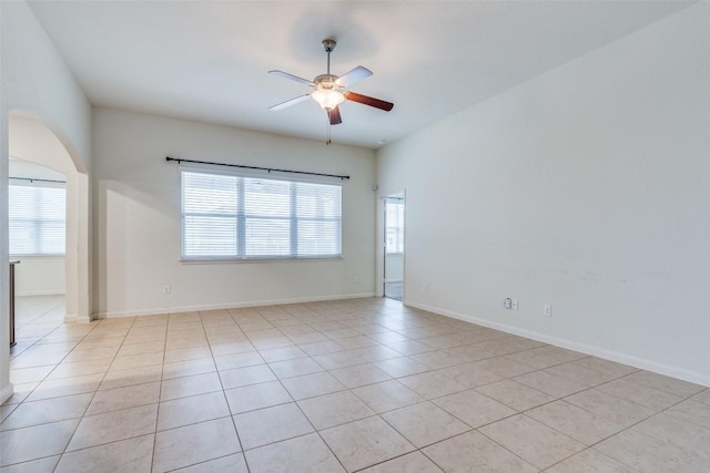 tiled empty room with ceiling fan