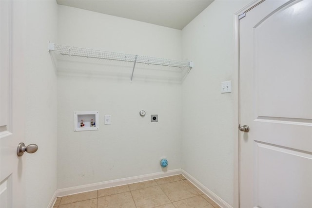 laundry area with hookup for an electric dryer, light tile patterned floors, and hookup for a washing machine