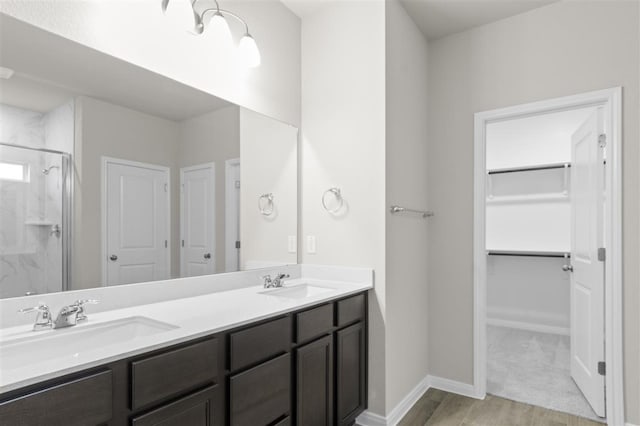 bathroom featuring vanity, hardwood / wood-style floors, and walk in shower